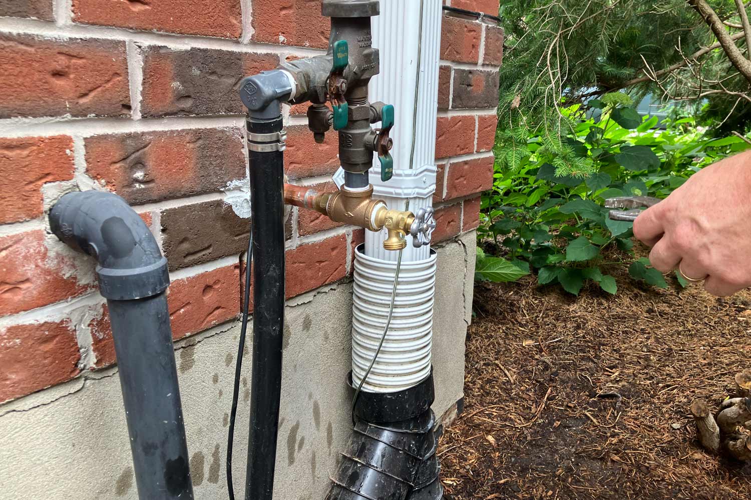 plumber in London, Ontario looking at an outdoor spigot doing a spring assessment